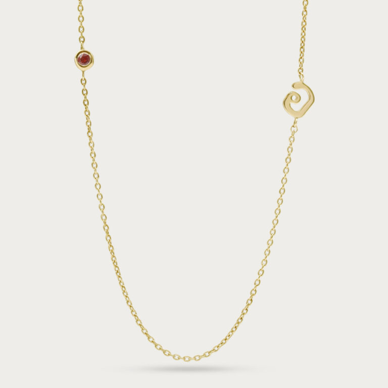 Initial pendant with a gemstone set beside the letter